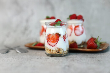 Selective Focus of Strawberry Parfait Dessert On Jars Isolated On Grey Background
