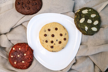 Top View Of Various Colorful Cookies Isolated On Brown Cloth 