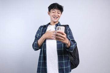 Cheerful Young Asian Man Suprised While Holding And Looking Smartphone Isolated On White Background