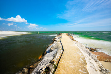Mexico Beach, Florida USA rocky jettie emerald-blue waters white sandy beaches blue sky