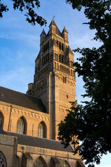 Sint-Salvators cathedral tower in the old town of the beautiful city of Bruges in Belgium at sunset.