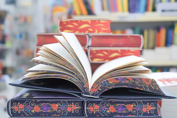 Open book on table with blur bookshelf background