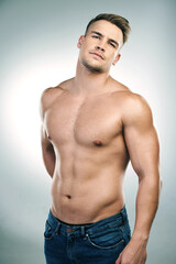 Portrait of man, abs and shirtless in studio with jeans for confidence, physical training or...