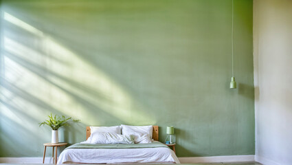 A bedroom with green walls looks comfortable and minimalist.