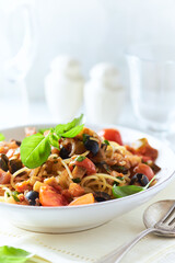 Spaghetti Pasta with Vegetables and fresh Basil on bright wooden Background.	