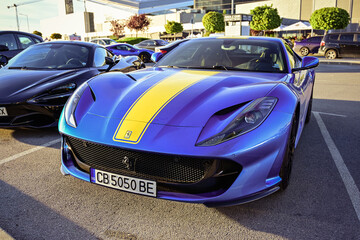 Obraz premium Italy- May 2024 Ferrari Blue car parked near a mountain. luxury sport Italian car