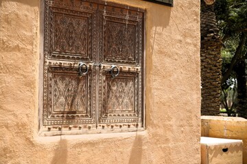 View on old arabic style wooden shutters in sunny day