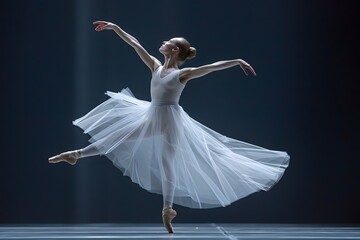 A woman in a white dress is dancing on a stage