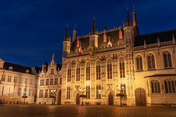 De Burg square and the city hall of the beautiful city of Bruges in Belgium at night, with its historic facades.
