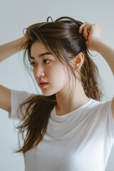 Fototapeta premium Woman Holding Hair in Air