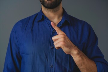 Man in Blue Shirt Pointing