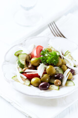 Various olives on white wooden background. Close up. Copy space