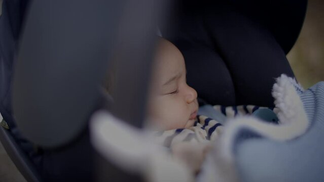 Young Baby Boy Lying in pram buggy Waking up after Sleeping
