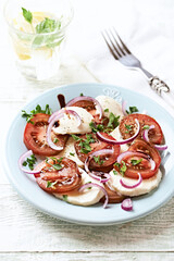 Summer Salad with Mozzarella Cheese, Tomatoes and red Onion. Wooden background. Close up. Copy space.	