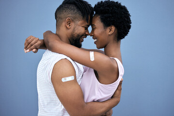 Vaccination, hug and black couple with plaster on arm in studio for cure, healthcare or booster...