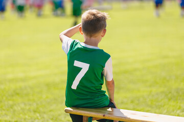 Young Boy Soccer Strike With Number Seven on Back. School Boy in Football Team. Child Sitting on Soccer Bench. Football Academy For Children