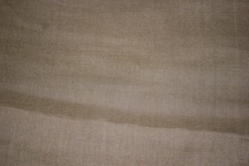 Surface of beige jersey fabric from above