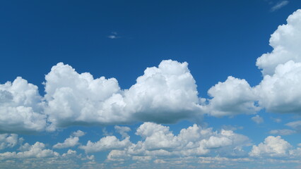 Blue heaven summer cloudscape. Rolling puffy white clouds are moving. Time lapse.