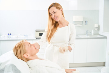 Fototapeta premium Leading expert of aesthetic medicine keeping primary consultation to woman