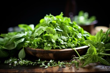 Variety of fresh culinary herbs in a rustic wooden bowl on a dark background