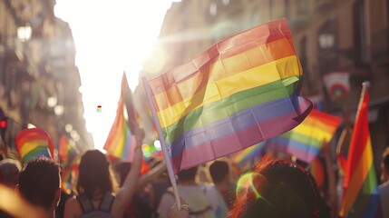 crowd waving rainbow flags at the gay pride parade pride day