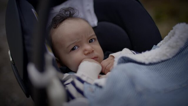 Young Baby Boy Lying in pram buggy Waking up after Sleeping