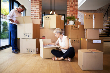 Boxes, moving and senior couple at new house for unpacking in living room for homeownership. Love,...