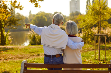 Old love is truest love. Romantic senior couple in love on date talking while sitting on park...