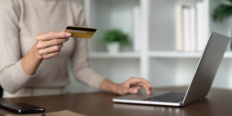 Woman use credit card on laptop and online shopping, payment and ecommerce at home, bank app and sale on store website with internet banking
