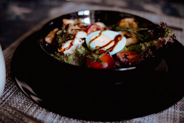 caprese salad and tomato bruschetta on black background