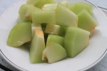 Melon slices in a plate on the table

