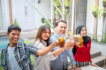 Portrait of multiethnic business colleagues toasting during a meeting