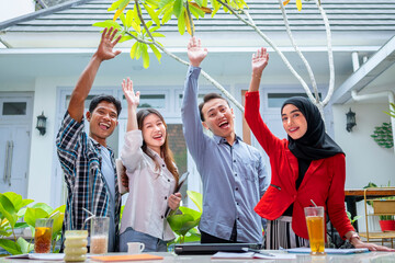 Indonesian business office teamwork for a startup company, smiling for a new collaboration.