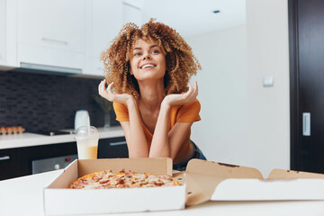 Young woman with curly hair enjoying a delicious pizza while sitting at a table in a cozy restaurant