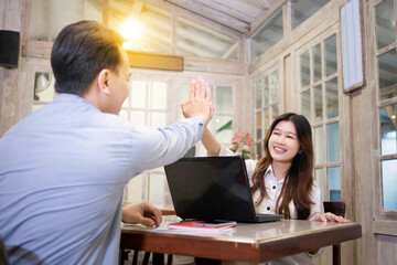 Portrait of multiethnic business colleagues high five during a meeting