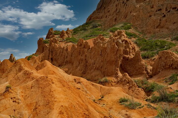 Obraz premium Northern Kyrgyzstan. Picturesque views of the famous Skazka Canyon (, the clay mountain peaks of which have bright colors from yellow to red-brown.