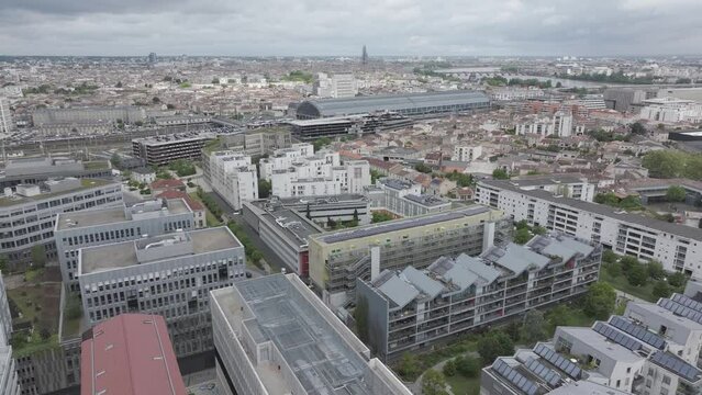Euroatlanitic city buildings area in Bordeaux France with The St. Jean Belcier train station near Garonne river, Aerial pan left shot