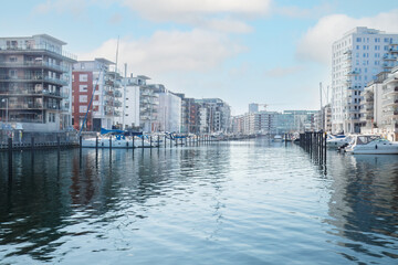 Cityscape at a Dockan Marina in Malmö, where boats dock in calm waters . Concepts: urban expansion, waterfront living, Malmö