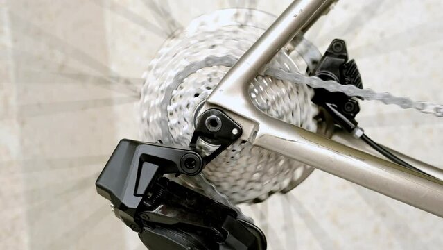 Сlose up of bike rear cassette and derailleur. Bike maintenance and repairing. Bicycle rear wheel spins. Rear derailleur bike in action.