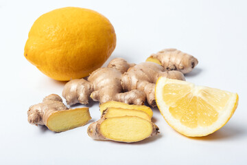 fresh ginger root and lemons beside, white background