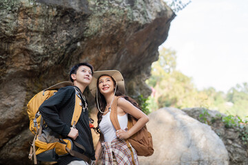 Lovely couple lesbian woman with backpack hiking in nature. Loving LGBT romantic moment in mountains