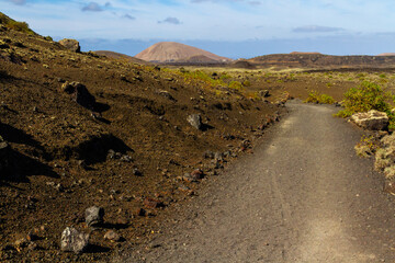 Trail around Montana Colorada. The path between the lava field. Lanzarote island, Canary islands,...