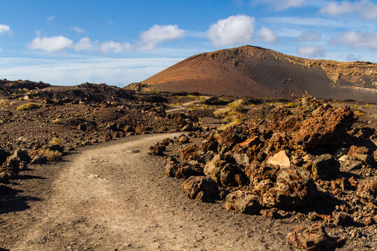 Trail around Montana Colorada. The path between the lava field. Lanzarote island, Canary islands, Spain, Europe