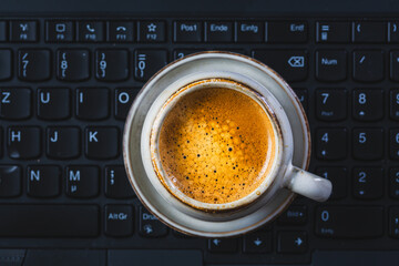 Coffee break in a office, cuo of espresso in a office. Workplace in a coffee shop or home office