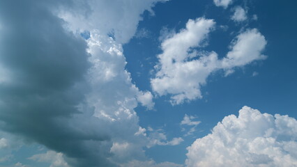 Cumulus cloud formations in sky before a thunderstorm. White puffy cumulus clouds forming on summer...