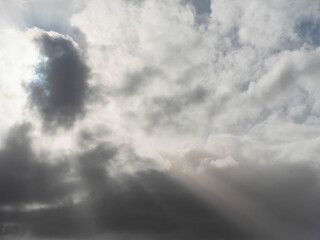 Obraz premium Dark dramatic storm sky background with rays of light. Nature background for design and sky replacement.