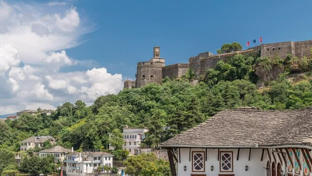 Panorama showing Gjirokastra city from the viewpoint with the fortress of the Ottoman castle of Gjirokaster timelapse. Albania aerial view to typical historic houses with stone roofs