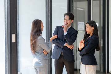 Group of young Asian business people stand brainstorm collaboration ideas at the office.