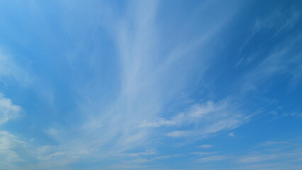 Floating fluffy clouds. Beautiful sunny blue sky with wispy smoky white cirrocumulus. Timelapse.
