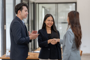 Asian business people shake hand to confirm the agreement in the business of mutual investment and...